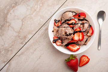 chocolate ice cream with strawberries on light. summer mood, delicious dessert, flat lay