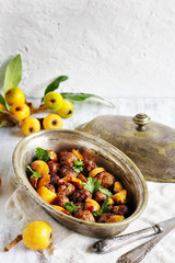 with a loquat dish. Meatballs with a loquat. or mini kebabs. medlar fruit with meatballs. Soft focus. Place for text. Copy Space