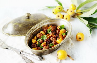 with a loquat dish. Meatballs with a loquat. or mini kebabs. medlar fruit with meatballs. Soft focus. Place for text. Copy Space