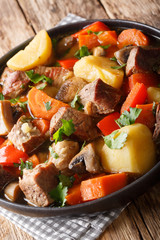 stew pork with vegetables close-up on a plate. vertical