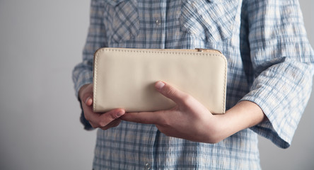 Caucasian business girl holding wallet.
