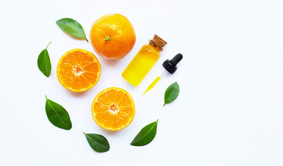 Essential oil with oranges on white.