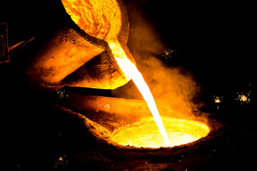 metal casting process with red high temperature fire in metal part factory