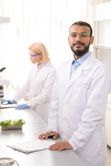 Confident young laboratory scientist