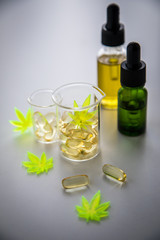 Pillen, Tabletten, Kapseln und Öl mit Cannabis Marihuana Hanf und CBD in Labor Becherglas gegen Schmerzen zur Therapie als Medizin 