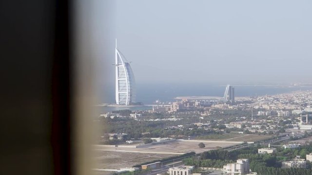 Picturesque view of Dubai city and blue from the window of a hotel room. Stock. Stunning view of the Burj Al Arab luxury hotel.