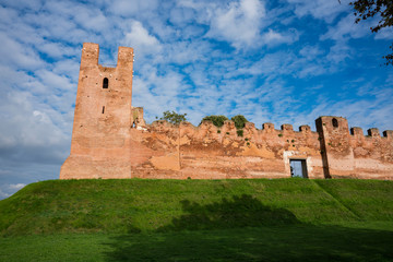 Fototapeta premium city wall with merlons and tower on green hill in Castelfranco Veneto, Italy