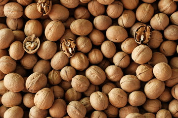 Natural fresh walnuts background pattern, texture. Natural food in-shell nuts walnuts pattern. Many Walnuts kernels.