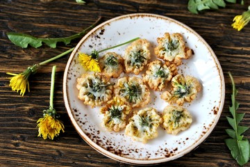 Fototapeta premium dandelion flowers fried in deep fried. Recipes from dandelion. organic healthy food. spring recipe. dishes from the first green.