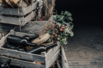 Empty wine bottles in a wooden box and grapes  with space for lettering or design.
