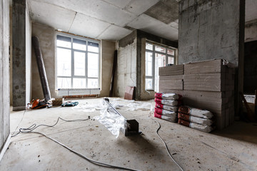 Interior of apartment with materials during on the renovation and construction remodel wall from