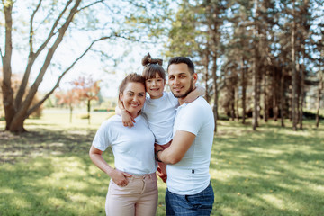 Fototapeta premium Happy family outdoors. Girl, mother, dad