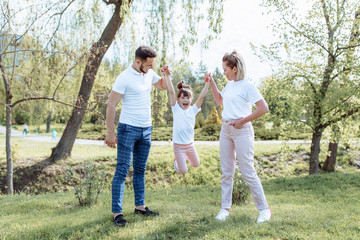 Fototapeta premium Happy family outdoors. Girl, mother, dad
