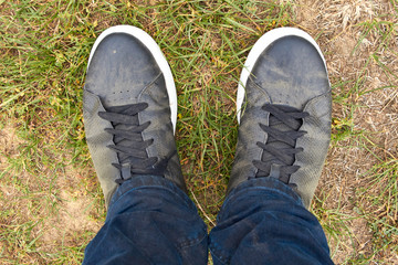 Feet close up. Traveler's dirty shoes. Man's shoes after the hike. Shoes are black in dust.