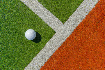 White dimple hockey ball on astro turf