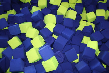 pool with colored toy cubes on baby playground