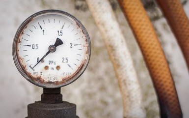 Close up of manometer & pressure hose. A pressure gauge on the background of water container....
