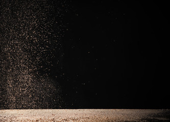 now dust falling on snow-covered table