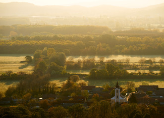 First light on the Hungarian countryside with a church