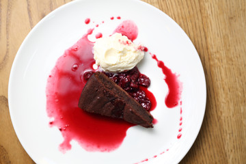  Brownie with raspberry sauce and ice cream.