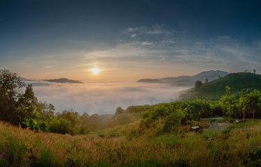 sunrise at Phu Huay Esan View Point, view of the hill around with sea of mist above Mekong river with blue sky background, Ban Muang, Sang Khom District, Nong Khai, Thailand.