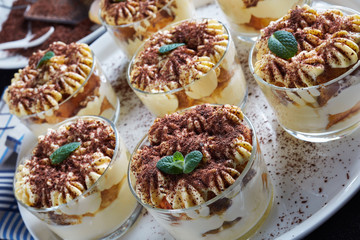 tiramisu in round glasses on a plate