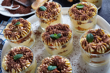 tiramisu in round glasses on a platter