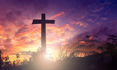 Silhouette the cross on sunset background