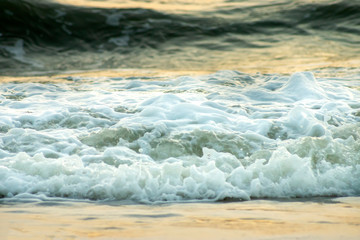 Soft wave on the beach with sunlight.