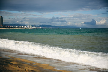 Beautiful beach on sunny day. Waves on the sea. Holiday travel concept. Barcelona Spain views.