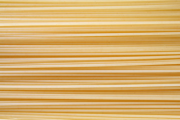 Spaghetti pasta vermicelli raw background lined in a row