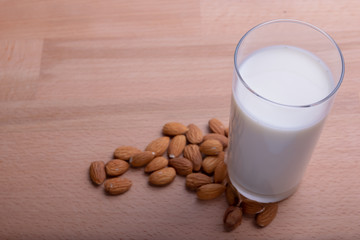 Glass of Almond milk and organic almonds on wooden background, Alternative Milk. Nuts milk