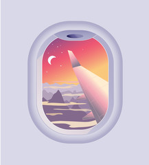 View from airplane window. Mountain landscape at sunrise or sunset. Flights and Travel