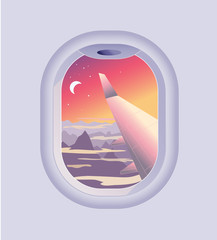 View from airplane window. Mountain landscape at sunrise or sunset. Flights and Travel