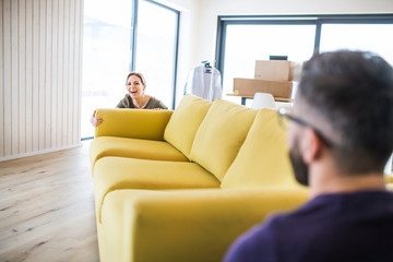 A young couple moving in new home.