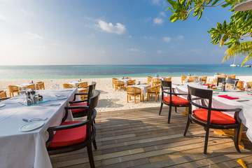 Beach restaurant with sea view, luxury tropical resort outdoor restaurant scene
