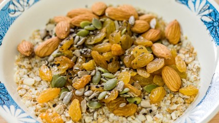Breakfast: oatmeal with raisins, pumpkin and sunflower seeds and almonds. Top view