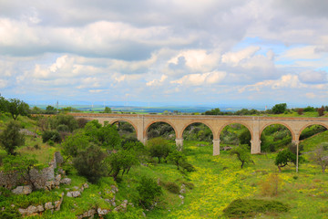 Fototapeta na wymiar Railway bridge through the picturesque landscape of Apulia, Italy