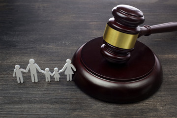Family figure and gavel on wooden table. Family law concept