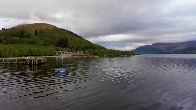 Aerial depiction of the beautiful village of Luss on the banks of Loch Lomond, featuring The Lodge on the Lake and Ben Lomond in the background.