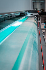 Details from a big, industrial, printer. Newspapers, magazines, billboards, and commercial panels. New generation robotized plotting machines for mass production and large format paper rolls. 