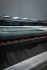 Details from a big, industrial, printer. Newspapers, magazines, billboards, and commercial panels. New generation robotized plotting machines for mass production and large format paper rolls. 