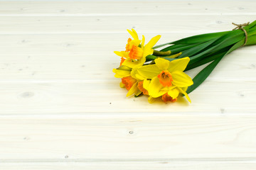 bunch of yellow daffodil on a wooden table background