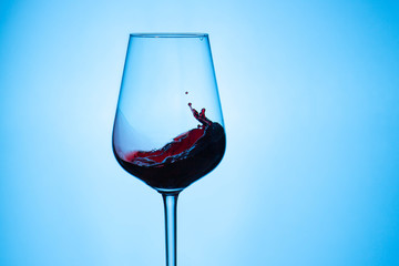 Splash of red wine in a glass.
