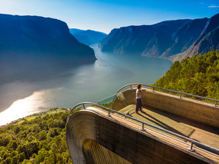 Tourist enjoying fjord view on Stegastein viewpoint Norway