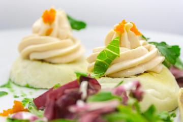 tartlets with red caviar, butter, sprigs of parsley and lettuce on a white plate on a white background