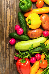 Fresh vegetables bunch greens on wooden background. Vegetarianism is a healthy lifestyle. Flat layout. View from above.