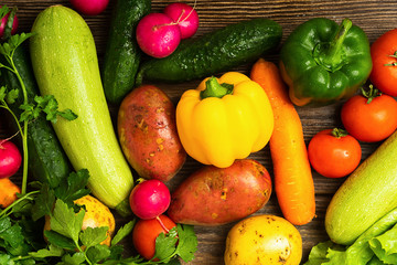 Fresh vegetables bunch greens on wooden background. Vegetarianism is a healthy lifestyle. Flat layout. View from above.