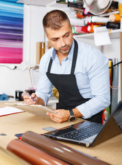 portrait of working advertising agency behind a laptop