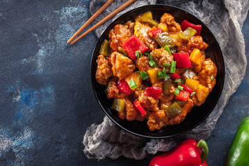 Sweet and sour chicken with colorful bell pepper on a plate